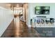 Hallway featuring hardwood floors, neutral paint, white wainscoting, and a view to the main living area at 12107 Grey Partridge Dr, Charlotte, NC 28278