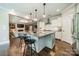 Open concept kitchen with granite counters, island seating, and stainless steel appliances at 12107 Grey Partridge Dr, Charlotte, NC 28278