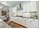 Modern kitchen with white cabinets and stainless steel hood over gas range at 12107 Grey Partridge Dr, Charlotte, NC 28278