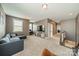 Spacious living room featuring a large TV, comfortable seating, and neutral carpeting at 12107 Grey Partridge Dr, Charlotte, NC 28278