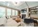 Bright living room features a coffered ceiling, built-in shelving, fireplace, and hardwood floors at 12107 Grey Partridge Dr, Charlotte, NC 28278