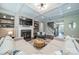 Bright living room featuring coffered ceiling, a fireplace, and an open staircase at 12107 Grey Partridge Dr, Charlotte, NC 28278