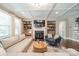 Cozy living room with a fireplace, built-in shelving, hardwood floors, and a coffered ceiling at 12107 Grey Partridge Dr, Charlotte, NC 28278