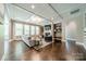 Open living room with coffered ceiling, built-in shelves, fireplace, and hardwood floors at 12107 Grey Partridge Dr, Charlotte, NC 28278