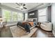 Comfortable main bedroom featuring dark wood floors, many windows, a ceiling fan and sitting area at 12107 Grey Partridge Dr, Charlotte, NC 28278
