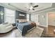 Comfortable main bedroom featuring dark wood floors, a ceiling fan and a view into the ensuite bathroom at 12107 Grey Partridge Dr, Charlotte, NC 28278
