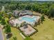 Aerial view of community pool, playground, and clubhouse surrounded by lush greenery and trees at 12107 Grey Partridge Dr, Charlotte, NC 28278