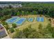 Aerial shot of community tennis and basketball courts nestled within mature trees and landscaping at 12107 Grey Partridge Dr, Charlotte, NC 28278