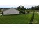 Expansive backyard with healthy green lawn, bordering manicured trees, and a view of the neighborhood at 123 Hanks Bluff Dr, Mooresville, NC 28117