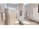 Well-lit bathroom featuring granite countertop, framed mirror, and shower with neutral tile at 123 Hanks Bluff Dr, Mooresville, NC 28117