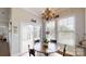Bright dining area featuring a chandelier, wood floors, and natural light at 123 Hanks Bluff Dr, Mooresville, NC 28117