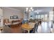 Open-concept dining room flows to the living room with wood floors at 123 Hanks Bluff Dr, Mooresville, NC 28117