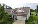 Charming home with attractive exterior elevation, lush landscaping, and a two-car garage at 123 Hanks Bluff Dr, Mooresville, NC 28117