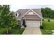 Charming home with a two-car garage, landscaped yard, and a welcoming front entrance at 123 Hanks Bluff Dr, Mooresville, NC 28117
