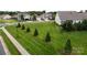 Well-manicured front yard featuring green lawn, trimmed trees, and sidewalk in a suburban neighborhood at 123 Hanks Bluff Dr, Mooresville, NC 28117