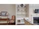 Cozy living room featuring built-in shelves, fireplace, and natural light at 123 Hanks Bluff Dr, Mooresville, NC 28117