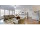 Open-concept living room with hardwood floors, flows seamlessly into the kitchen and dining area at 123 Hanks Bluff Dr, Mooresville, NC 28117
