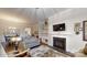 Elegant living room featuring a fireplace, built-in shelving, and hardwood flooring at 123 Hanks Bluff Dr, Mooresville, NC 28117