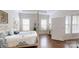 Tranquil main bedroom with natural light, tray ceiling, and hardwood flooring at 123 Hanks Bluff Dr, Mooresville, NC 28117