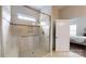 Modern glass enclosed shower with tiled surround and chrome fixtures at 123 Hanks Bluff Dr, Mooresville, NC 28117
