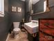 Elegant bathroom with a dark accent wall, featuring a vintage-style sink and decor at 1325 Marshville Olive Branch Rd, Marshville, NC 28103