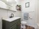 Charming bathroom features modern vanity, white wainscoting, and stylish black hardware at 1325 Marshville Olive Branch Rd, Marshville, NC 28103