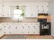 Bright kitchen features ample white cabinetry, neutral countertops, and a black range at 1325 Marshville Olive Branch Rd, Marshville, NC 28103