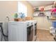 Well-organized laundry room with shelving above washer and dryer, creating a functional space at 1325 Marshville Olive Branch Rd, Marshville, NC 28103