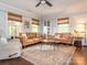 Inviting living room with wood floors, a ceiling fan, and comfortable seating around a circular coffee table at 1325 Marshville Olive Branch Rd, Marshville, NC 28103