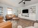 Bright living room with built-in shelves, a ceiling fan, and stylish seating around a coffee table at 1325 Marshville Olive Branch Rd, Marshville, NC 28103