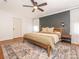 This main bedroom boasts a dark accent wall and hardwood flooring, offering a sophisticated retreat at 1325 Marshville Olive Branch Rd, Marshville, NC 28103