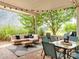 Outdoor patio setup with string lights, a dining table, and a cozy seating area surrounded by lush greenery at 1325 Marshville Olive Branch Rd, Marshville, NC 28103