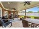 Inviting covered back patio with brick columns, ceiling fans, and outdoor furniture at 133 43Rd Avenue Nw Ln, Hickory, NC 28601