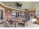 Relaxing covered back patio with stone flooring, seating arrangements, and ceiling fans at 133 43Rd Avenue Nw Ln, Hickory, NC 28601