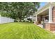Backyard featuring a brick patio with an outdoor kitchen area and lush green lawn at 133 43Rd Avenue Nw Ln, Hickory, NC 28601