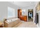 Elegant bathroom featuring a soaking tub, tiled floors, granite countertops, and a glass block window at 133 43Rd Avenue Nw Ln, Hickory, NC 28601