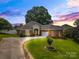 Inviting brick home featuring a well-manicured lawn, landscaped front yard, and a paved driveway at 133 43Rd Avenue Nw Ln, Hickory, NC 28601