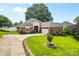 Charming brick home featuring a well-manicured lawn, landscaped front yard, and a paved driveway at 133 43Rd Avenue Nw Ln, Hickory, NC 28601