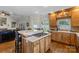 Open-concept kitchen with light wood cabinets, a gas cooktop island, and stainless appliances at 133 43Rd Avenue Nw Ln, Hickory, NC 28601