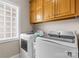 Functional laundry room equipped with modern washer and dryer beneath wooden cabinets at 133 43Rd Avenue Nw Ln, Hickory, NC 28601