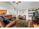 Inviting living room featuring a leather sofa, ceiling fan, and dark wood flooring with a decorative rug at 133 43Rd Avenue Nw Ln, Hickory, NC 28601