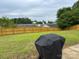 Fenced backyard with lush green grass and mature trees at 1421 Piney Church Rd, Concord, NC 28025