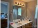 Clean bathroom features vanity with modern fixtures and good mirror lighting at 1421 Piney Church Rd, Concord, NC 28025