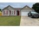 Inviting single-story home with a well-manicured lawn and a convenient two-car garage at 1421 Piney Church Rd, Concord, NC 28025