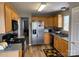 Efficient kitchen with wooden cabinets, stainless steel appliances, and good counter space at 1421 Piney Church Rd, Concord, NC 28025