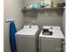 Efficient laundry area with white washer and dryer and upper storage shelf at 1421 Piney Church Rd, Concord, NC 28025