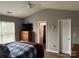 Relaxing main bedroom featuring a bed, dresser, and window, with the en-suite bathroom visible at 1421 Piney Church Rd, Concord, NC 28025