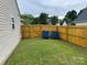 Well-maintained side yard featuring lush grass and a wooden privacy fence at 1421 Piney Church Rd, Concord, NC 28025