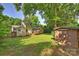 Expansive backyard features a storage shed and mature trees, offering privacy and space at 1522 Barberry Ct, Charlotte, NC 28211