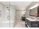 This primary bathroom features a seamless glass shower and a double vanity with modern fixtures at 1522 Barberry Ct, Charlotte, NC 28211